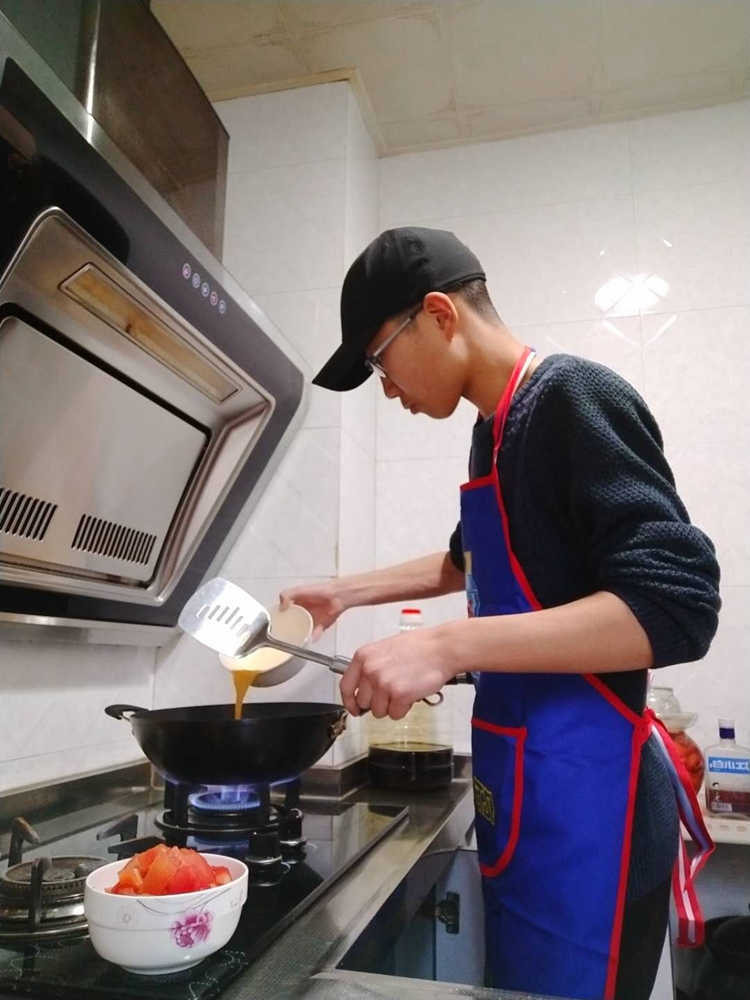 高一(2)班刘忠信在家里做饭.jpg